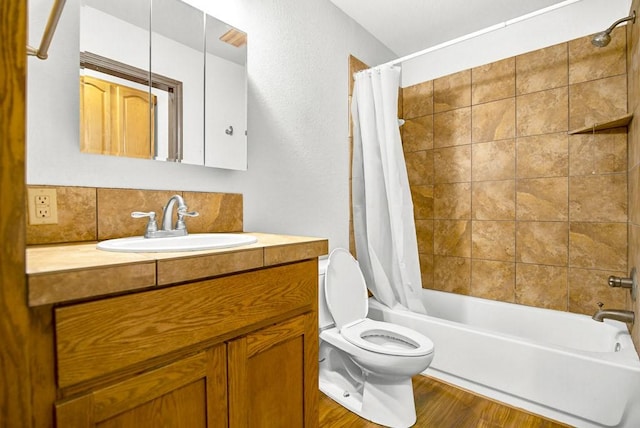 bathroom with wood finished floors, shower / tub combo with curtain, toilet, and vanity
