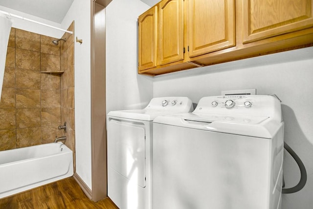 laundry area featuring dark wood-type flooring and washer and clothes dryer