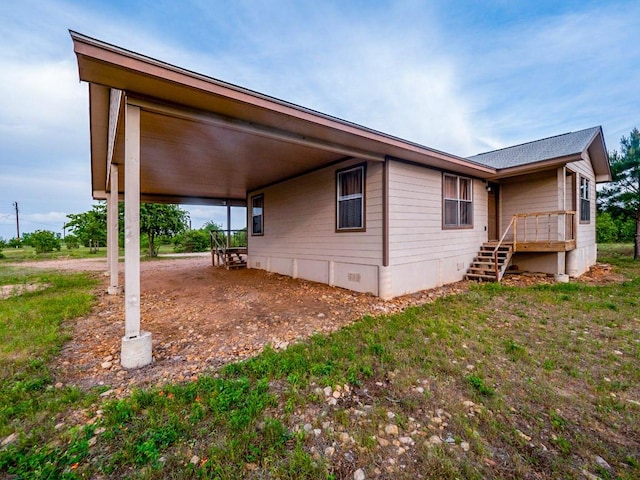 exterior space featuring a carport and stairway