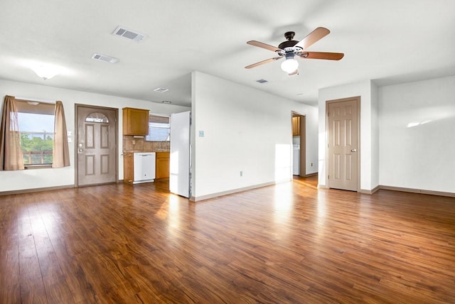 unfurnished living room with baseboards, visible vents, a ceiling fan, and dark wood-type flooring