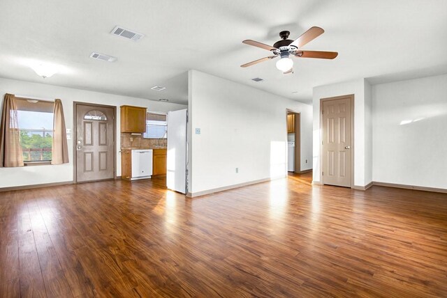 121 Hudson Rd, Smithville, TX 78957 - unfurnished living room with a ceiling fan, dark wood-style floors, and washer / clothes dryer