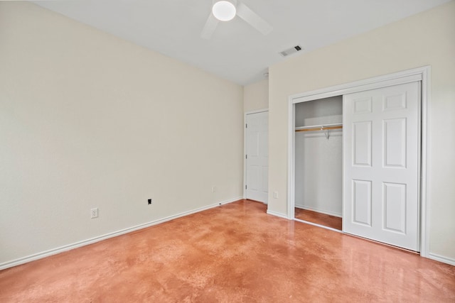 unfurnished bedroom featuring concrete flooring, a closet, ceiling fan, visible vents, and baseboards