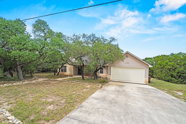 ranch-style home with a front lawn, driveway, and a garage
