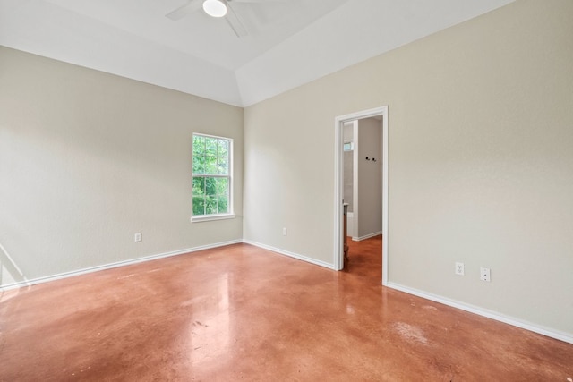 unfurnished room featuring finished concrete flooring, ceiling fan, lofted ceiling, and baseboards