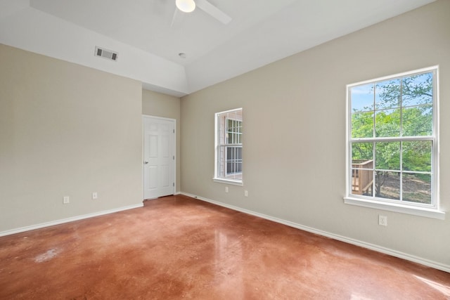 empty room with baseboards, ceiling fan, and concrete floors