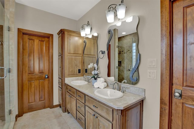 full bathroom with a shower stall, tile patterned flooring, and a sink