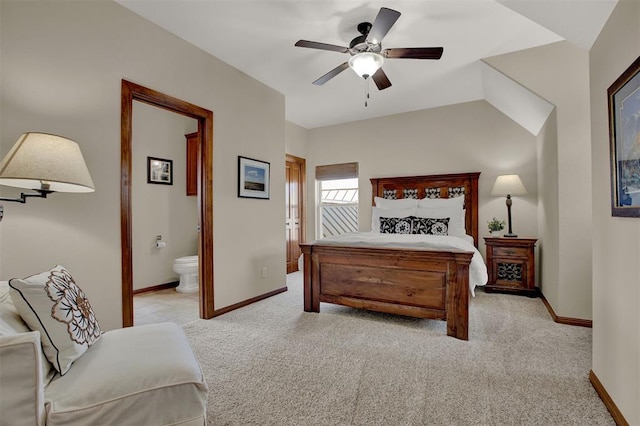 bedroom featuring baseboards, light carpet, connected bathroom, and ceiling fan