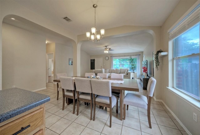 dining room with visible vents, light tile patterned floors, ceiling fan with notable chandelier, and arched walkways