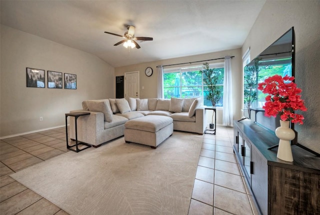 living room featuring ceiling fan, light tile patterned flooring, and plenty of natural light