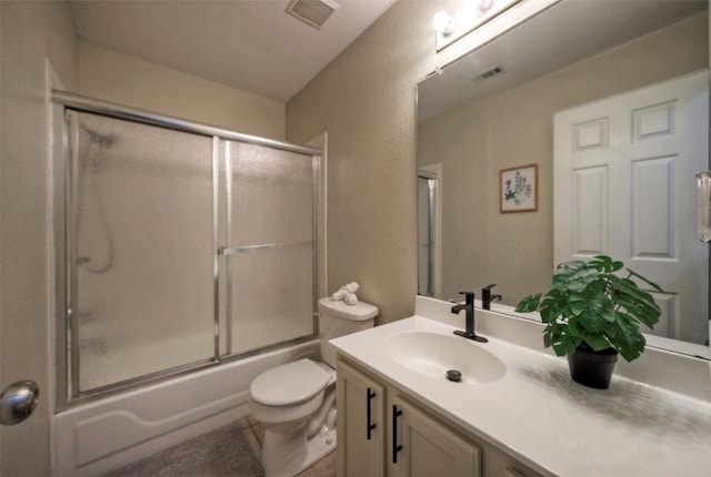 bathroom featuring toilet, visible vents, vanity, and enclosed tub / shower combo