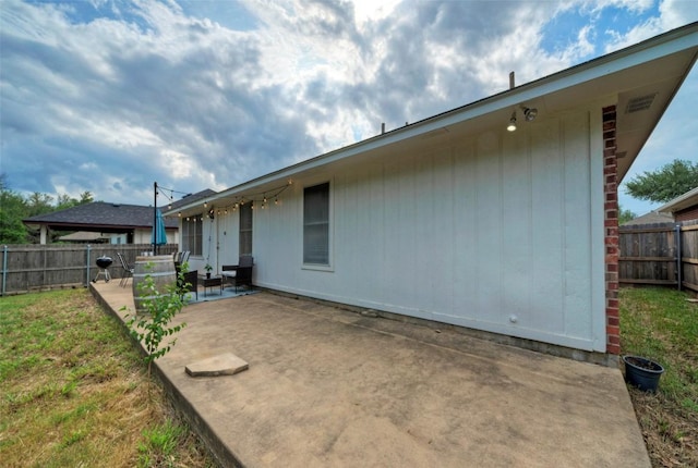 back of house with a patio area and a fenced backyard