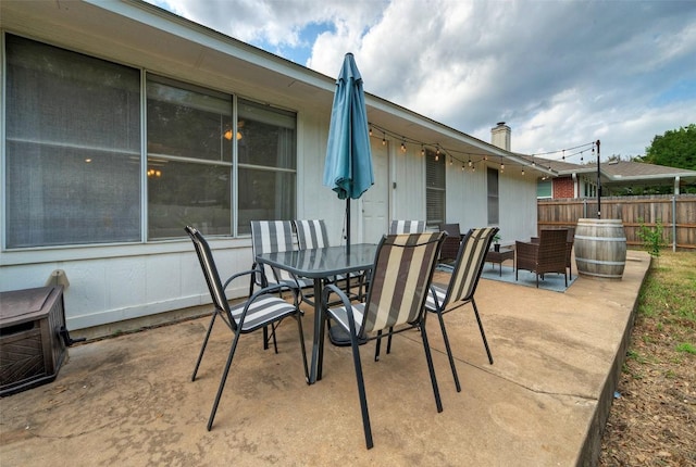 view of patio / terrace featuring outdoor dining area and fence