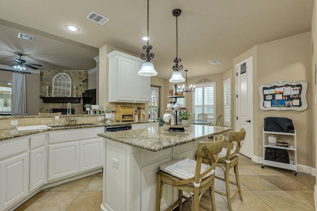 2600 Dalea St, Round Rock, TX 78681 - kitchen with visible vents, light tile patterned floors, light stone countertops, and a sink