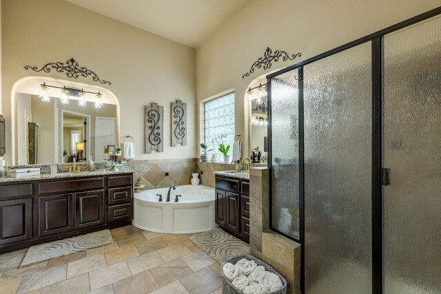 2600 Dalea St, Round Rock, TX 78681 - bathroom with a bath, two vanities, a shower stall, and stone finish floors