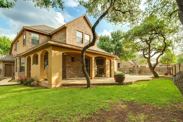 2600 Dalea St, Round Rock, TX 78681 - rear view of property with fence, a lawn, a patio, and brick siding