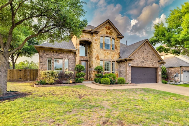 2600 Dalea St, Round Rock, TX 78681 - french country style house with driveway, an attached garage, stone siding, brick siding, and roof with shingles