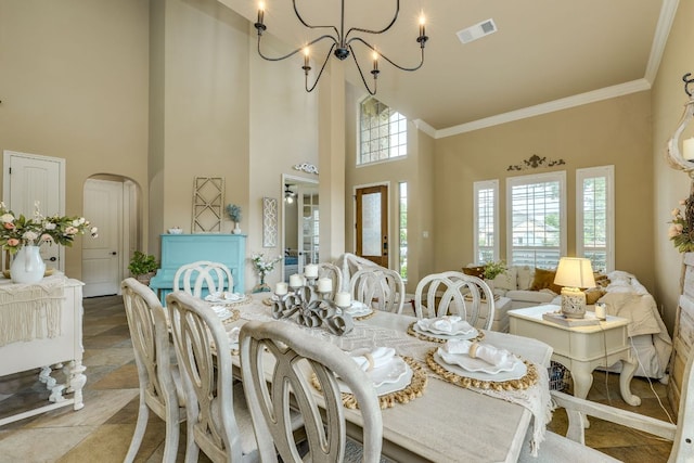 2600 Dalea St, Round Rock, TX 78681 - dining room featuring visible vents, arched walkways, an inviting chandelier, ornamental molding, and a high ceiling