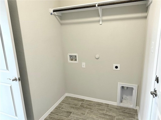 washroom featuring hookup for an electric dryer, gas dryer hookup, baseboards, hookup for a washing machine, and laundry area