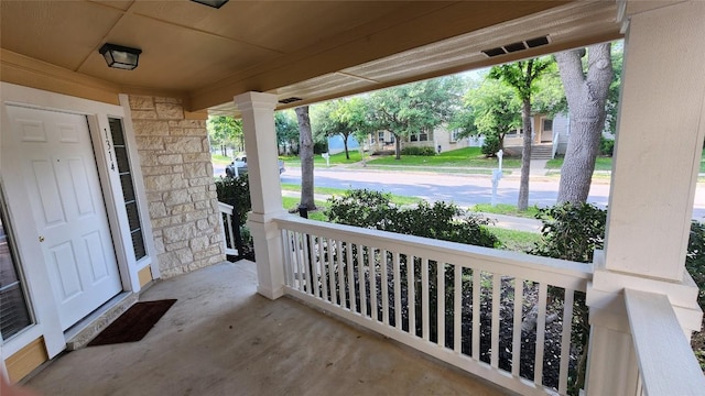 view of patio / terrace featuring a porch and visible vents