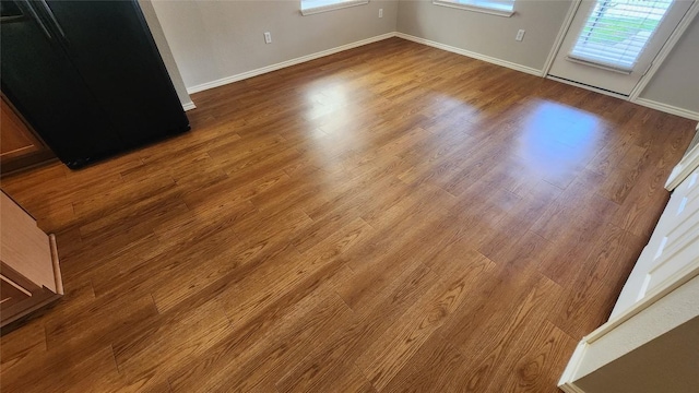interior space with wood finished floors and baseboards