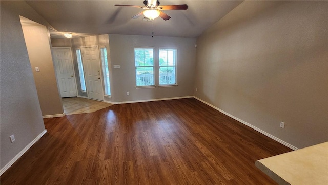 foyer featuring wood finished floors, a ceiling fan, and baseboards