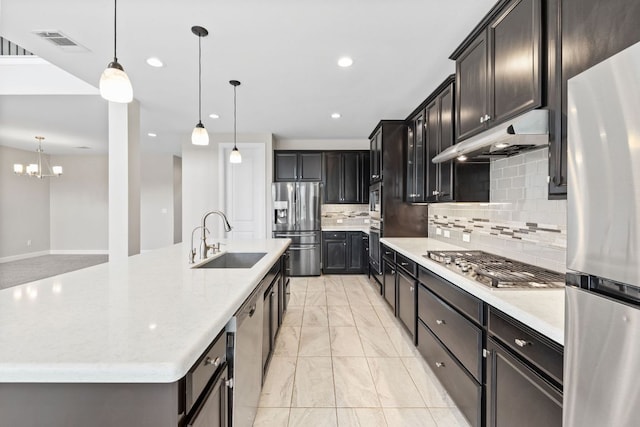 829 Expedition Way, Round Rock, TX 78665 - kitchen with stainless steel appliances, decorative backsplash, a large island, light marble finish flooring, and under cabinet range hood
