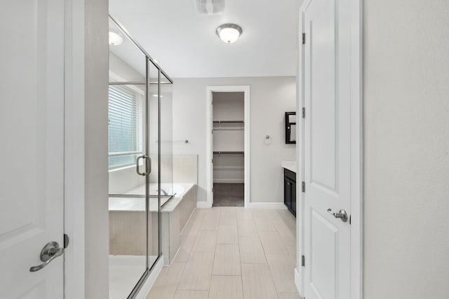 829 Expedition Way, Round Rock, TX 78665 - full bathroom with a stall shower, vanity, a spacious closet, and a bathtub