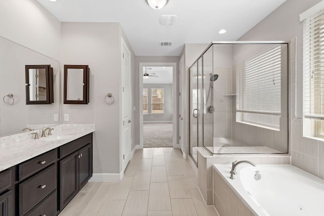 829 Expedition Way, Round Rock, TX 78665 - bathroom with a bath, vanity, a shower stall, and ceiling fan