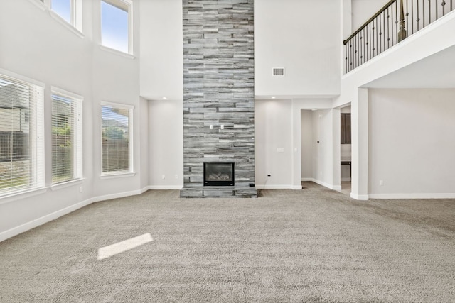 829 Expedition Way, Round Rock, TX 78665 - unfurnished living room featuring a high ceiling, carpet, and a tile fireplace