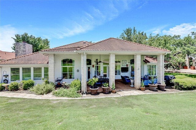93 Duck Lake Dr, Lakeway, TX 78734 - back of property featuring a yard, a tile roof, and a chimney