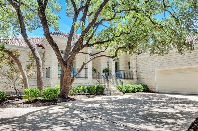 93 Duck Lake Dr, Lakeway, TX 78734 - view of front of home with driveway and a garage