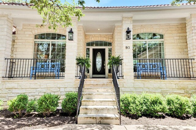 93 Duck Lake Dr, Lakeway, TX 78734 - doorway to property featuring stone siding and covered porch