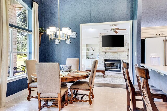 93 Duck Lake Dr, Lakeway, TX 78734 - dining room featuring a fireplace, plenty of natural light, wallpapered walls, ceiling fan, and a chandelier