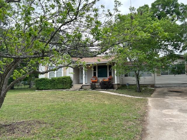 11600 Hornsby St, Austin, TX 78753 - view of property hidden behind natural elements featuring a front yard and driveway