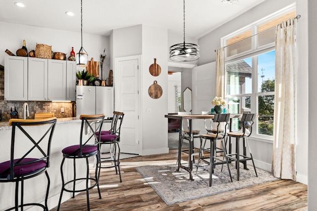 101 Durango Dr, Johnson City, TX 78636 - dining space featuring baseboards, recessed lighting, wood finished floors, and a healthy amount of sunlight