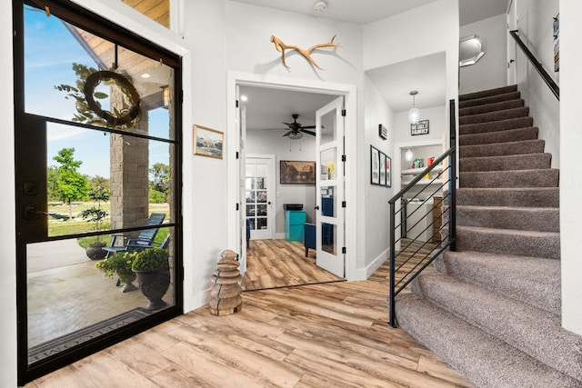 101 Durango Dr, Johnson City, TX 78636 - entrance foyer featuring wood finished floors, ceiling fan, baseboards, and stairs