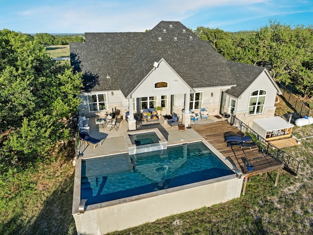 101 Durango Dr, Johnson City, TX 78636 - rear view of house featuring a patio, outdoor lounge area, a shingled roof, and stucco siding