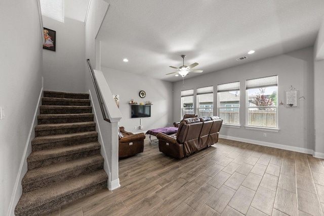 3750 E Palm Valley Blvd Unit 98, Round Rock, TX 78665 - living room featuring stairway, ceiling fan, visible vents, baseboards, and wood finished floors