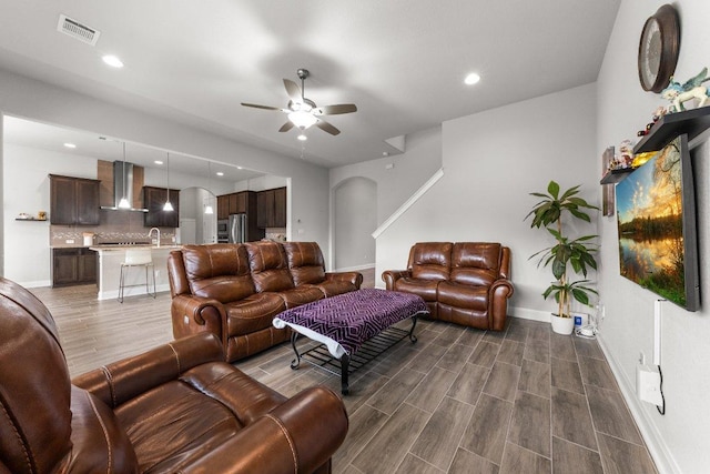 3750 E Palm Valley Blvd Unit 98, Round Rock, TX 78665 - living room with a ceiling fan, dark wood-style floors, recessed lighting, and arched walkways