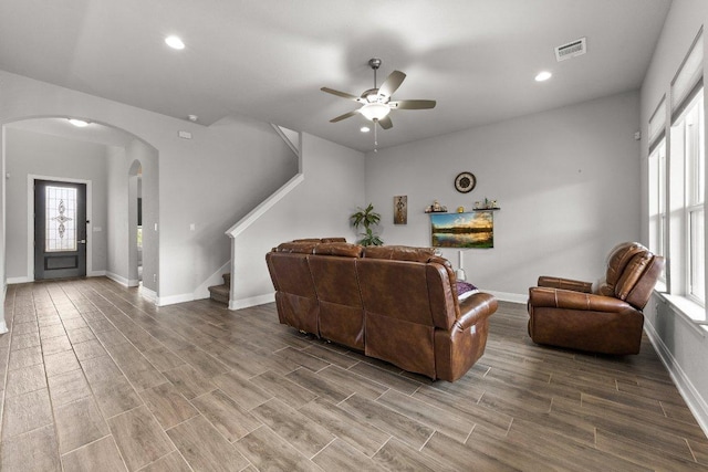 3750 E Palm Valley Blvd Unit 98, Round Rock, TX 78665 - living room with stairway, visible vents, ceiling fan, baseboards, and arched walkways