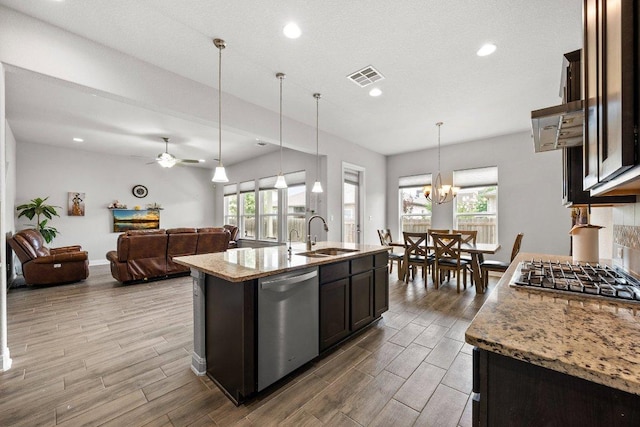 3750 E Palm Valley Blvd Unit 98, Round Rock, TX 78665 - kitchen featuring appliances with stainless steel finishes, wood finished floors, light stone counters, recessed lighting, and an island with sink