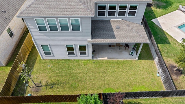 3750 E Palm Valley Blvd Unit 98, Round Rock, TX 78665 - back of property featuring a lawn, a fenced backyard, a shingled roof, and a patio area