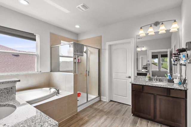 3750 E Palm Valley Blvd Unit 98, Round Rock, TX 78665 - bathroom with a bath, visible vents, a shower stall, and vanity