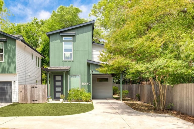506 Thrasher Ln Unit 2, Austin, TX 78741 - view of front of home with driveway, fence, board and batten siding, a carport, and a garage