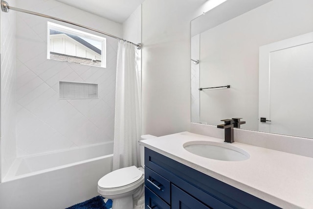 bathroom featuring toilet, shower / bath combo with shower curtain, and vanity