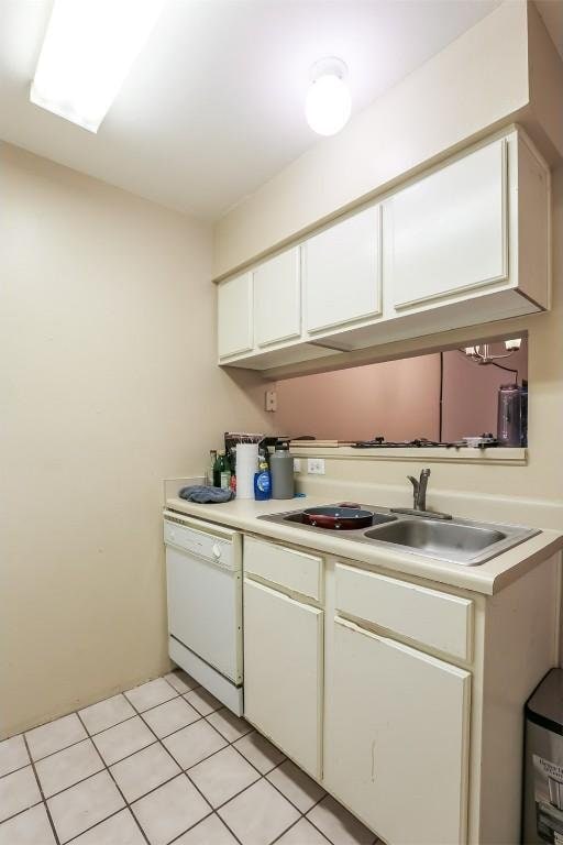 kitchen featuring a sink, light tile patterned floors, white dishwasher, white cabinetry, and light countertops