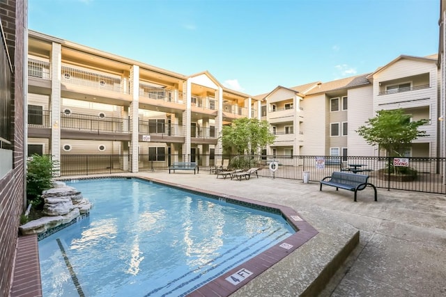 pool featuring a patio and fence
