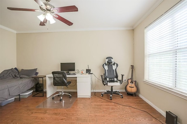 home office with ornamental molding, light wood finished floors, ceiling fan, and baseboards