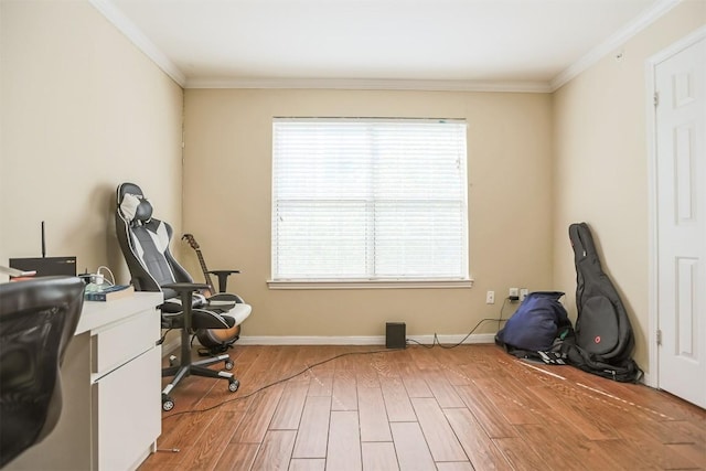 home office featuring baseboards, ornamental molding, light wood finished floors, and plenty of natural light