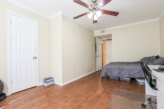 bedroom with crown molding, visible vents, ceiling fan, and wood finished floors
